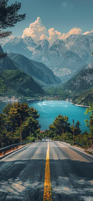 通往山间湖泊的公路，远处是连绵的雪山和蓝天白云 手机壁纸