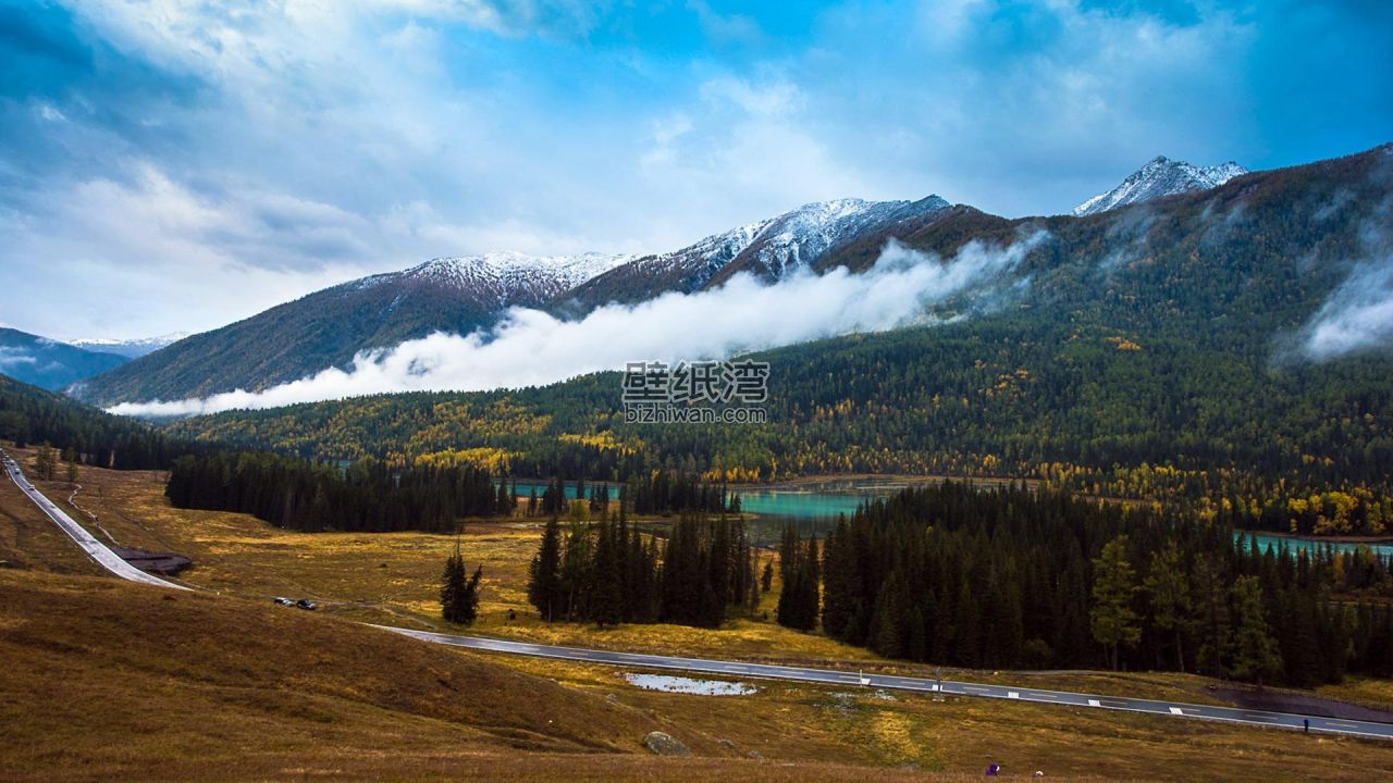 雪山与森林环绕的湖泊风光图片